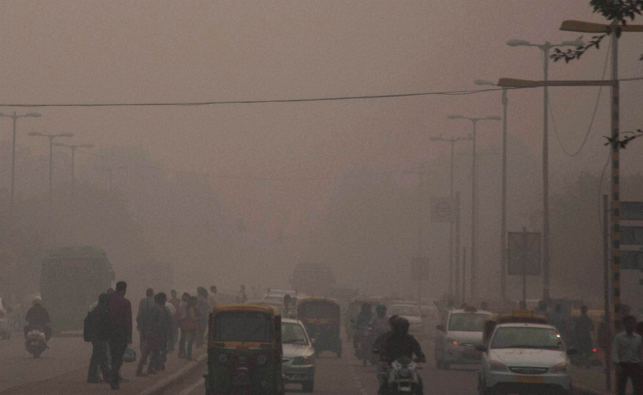 Gurgaon: People walking through smog due to increase in air pollution after Diwali celebrations in Gurgaon on Thursday. (Source: PTI)